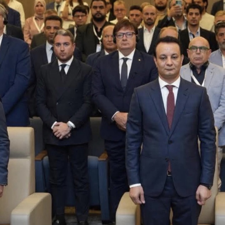 Enrico Celiberti in piedi tra gli ospiti in platea a una conferenza istituzionale